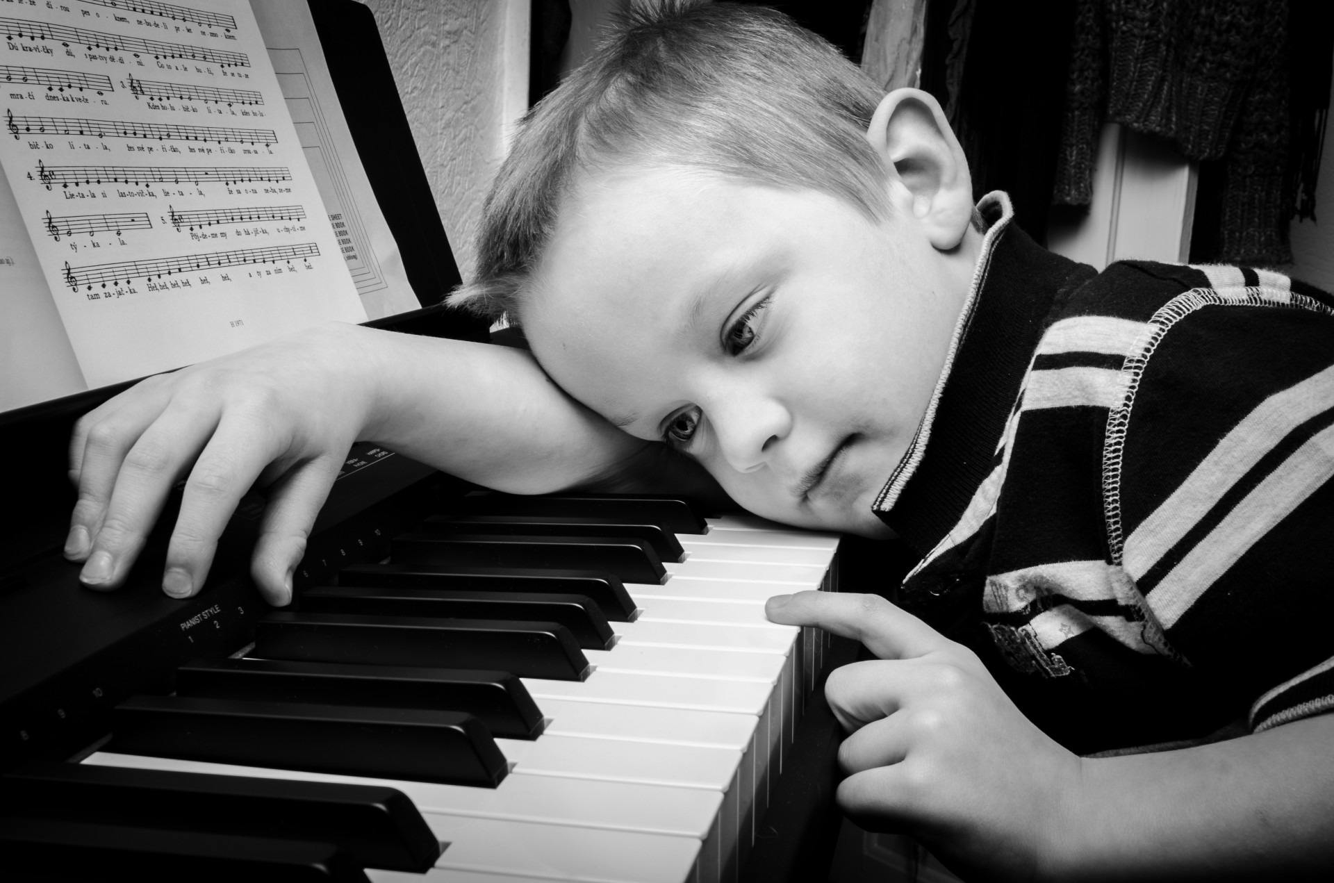 small child learning piano