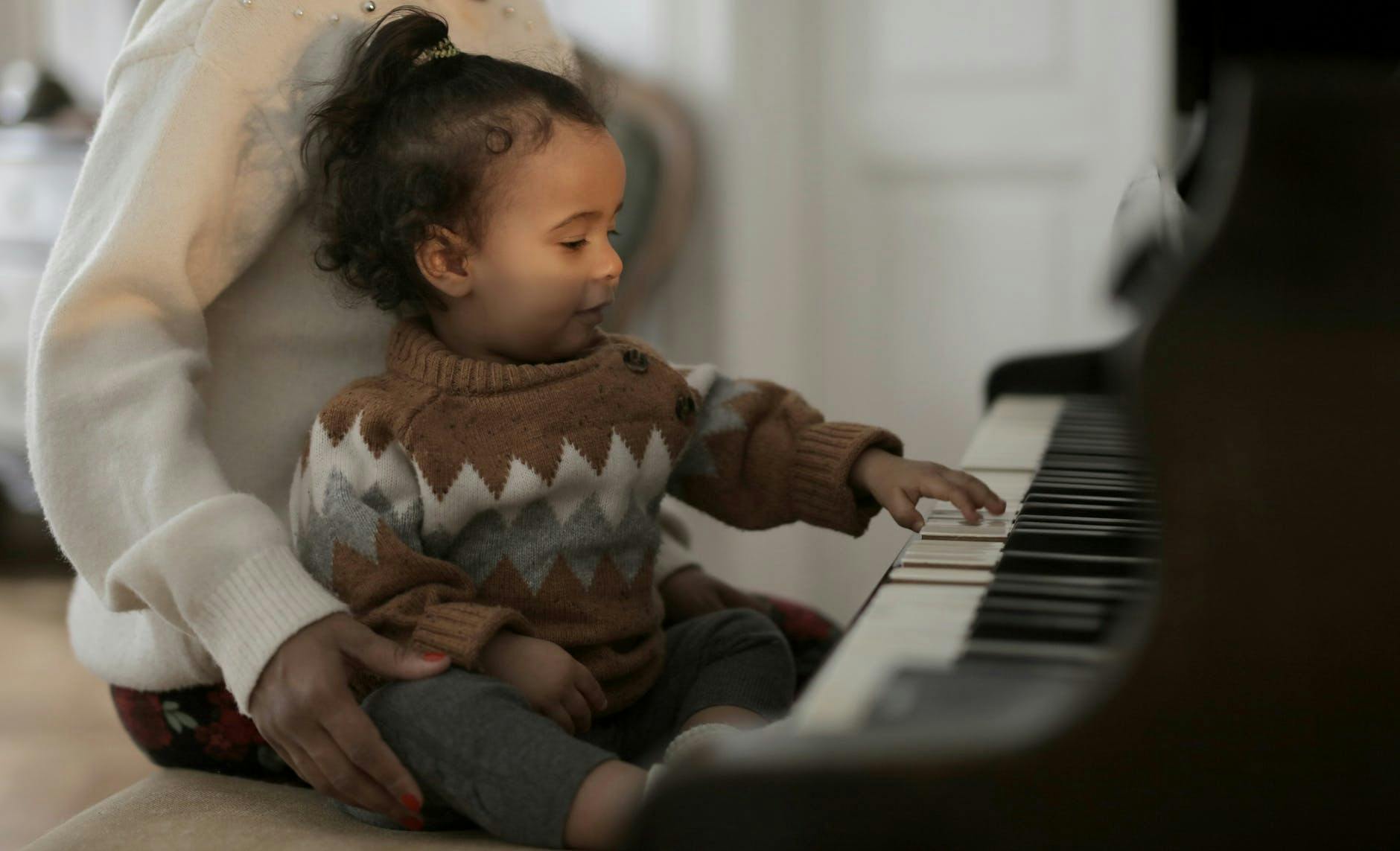 small child playing music keyboard