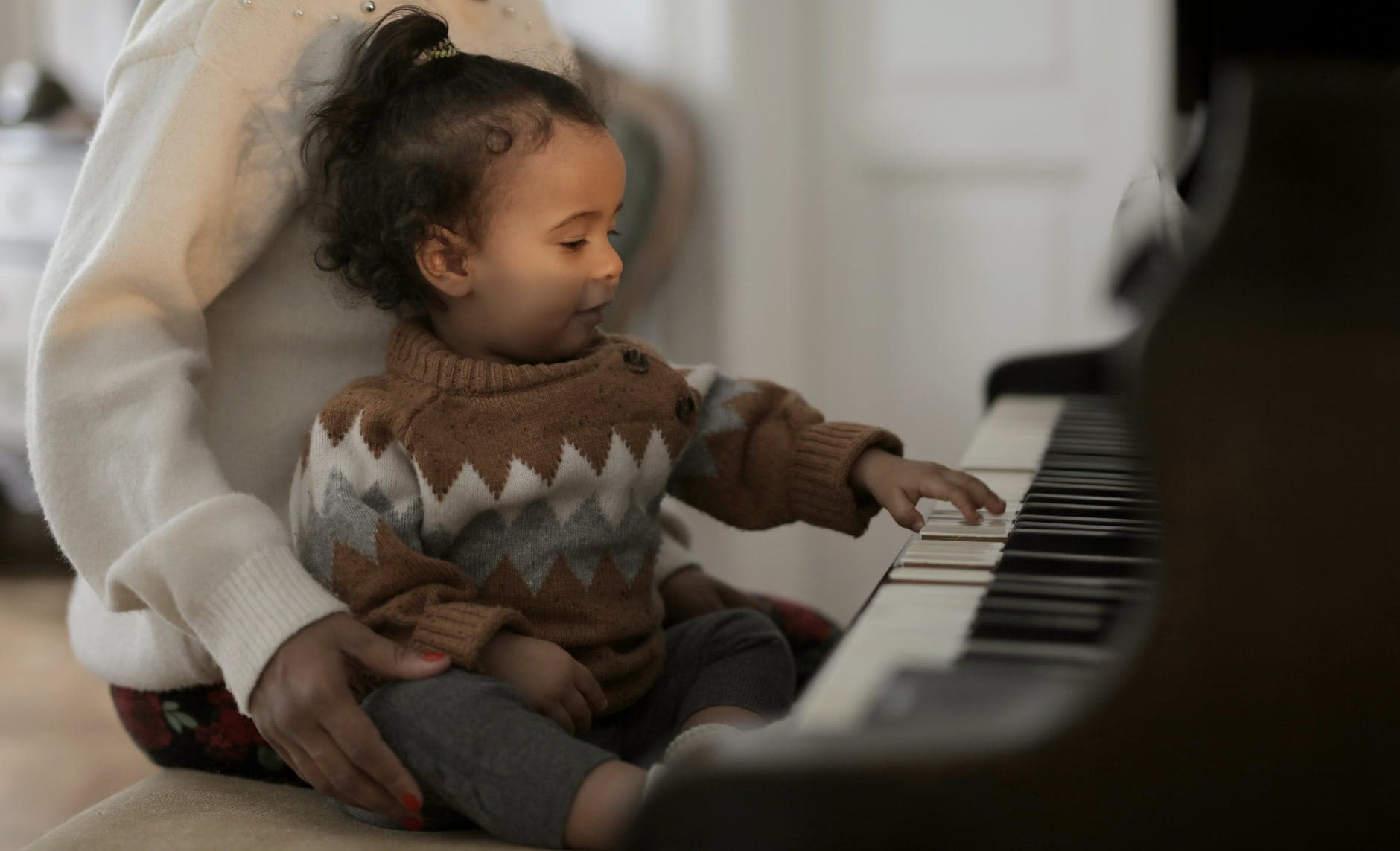 small child playing music keyboard